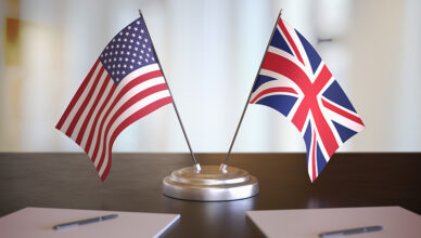 USA and UK flags placed side by side on a table.