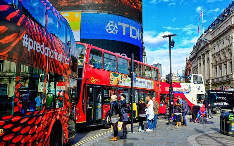 People Walking on Street Near Red Bus, london