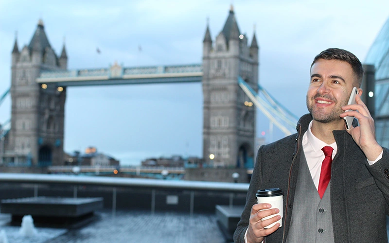 Businessman calling by phone near the Tower Bridge
