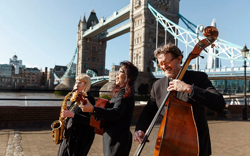 Medium shot people making music outdoors