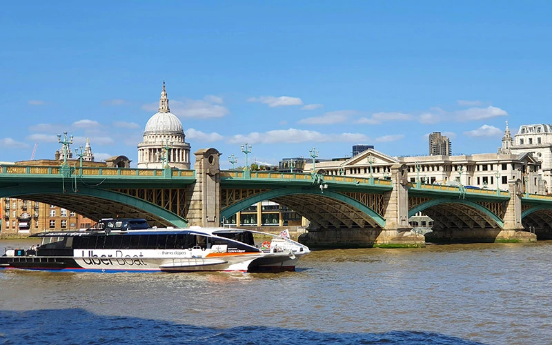 Tour Boat on a River Passing under the Bridge in a london