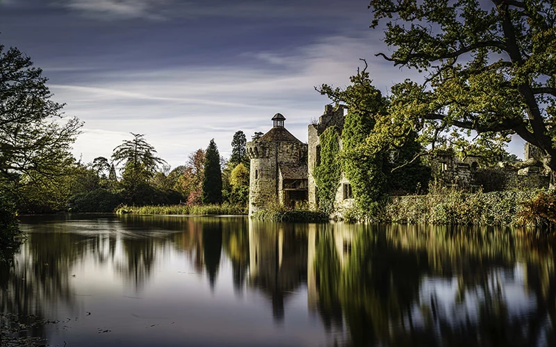 Castle reflecting in a clear lake at Bourton-on-the-Water, UK