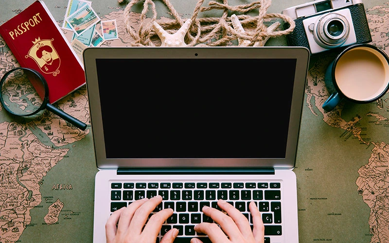 Traveller typing on laptop