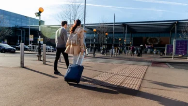 Full shot couple walking with baggage