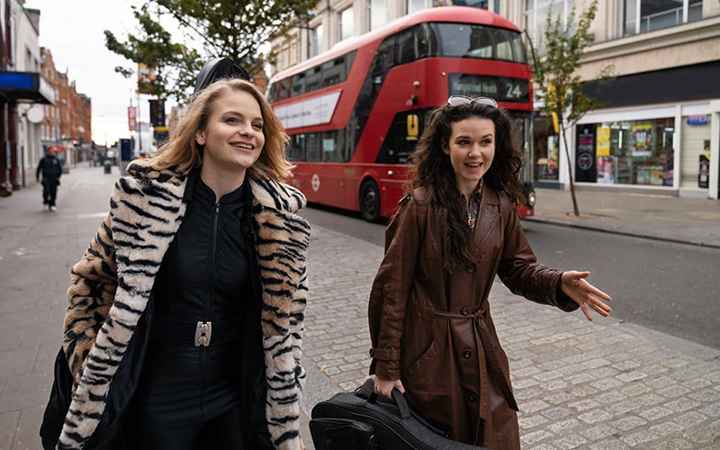 Young women walking around London city.