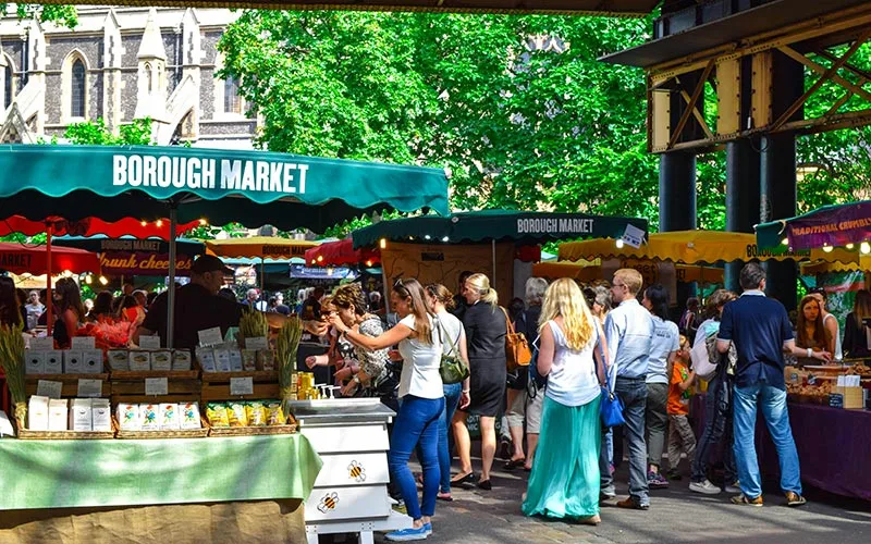People walking through Borough Market in London.