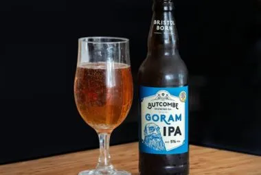 Close-up of a Glass and Bottle of Beer Standing on the Table